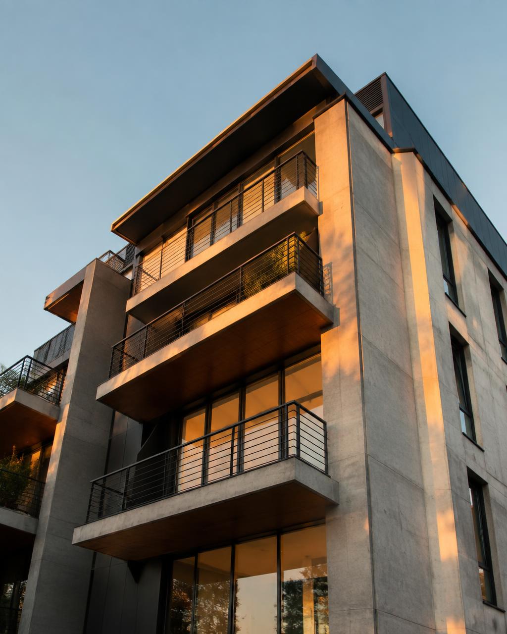 Modern concrete and steel residential building at golden hour